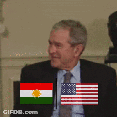 Man In Suit Standing Before Flags GIF