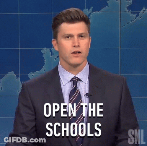 Man In Suit Standing Before Open Schools Sign GIF