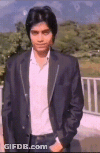Man In Suit Standing Before Railing GIF