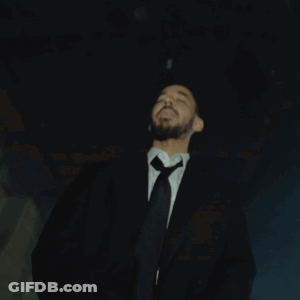 Man In Suit Standing Before Right Sign GIF