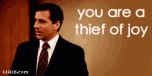 Man In Suit Standing Before You Are A Thief Of Joy Sign GIF