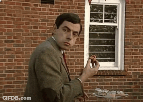 Man In Suit Standing By Brick Wall GIF