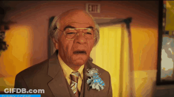 Man In Suit Standing By Exit Sign GIF