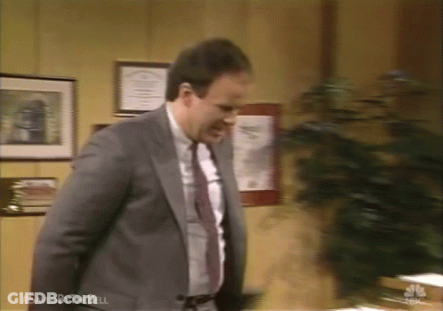Man In Suit Standing By Saved By The Bell Sign GIF