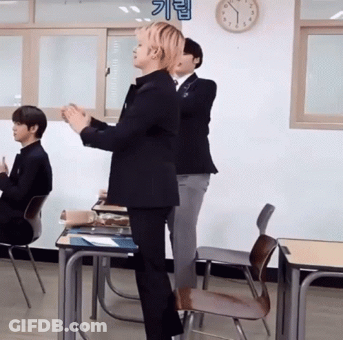Man In Suit Standing In Classroom GIF