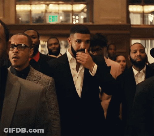 Man In Suit Standing In Crowd GIF