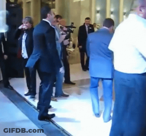 Man In Suit Standing In Crowd GIF
