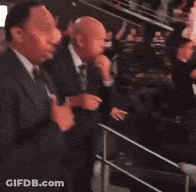 Man In Suit Standing In Dark Room GIF