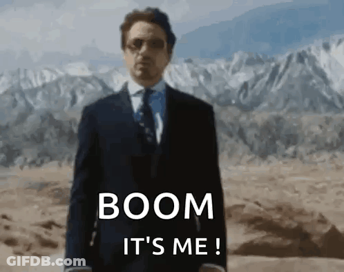 Man In Suit Standing In Desert With Mountains GIF