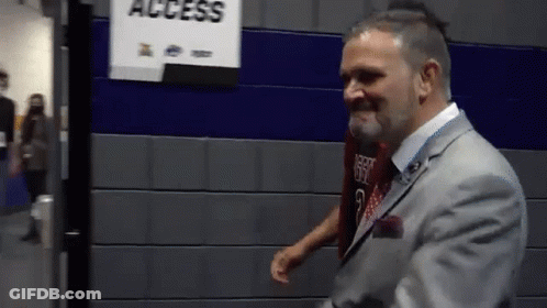 Man In Suit Standing In Front Of Access Sign GIF