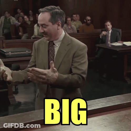 Man In Suit Standing In Front Of Big Sign GIF