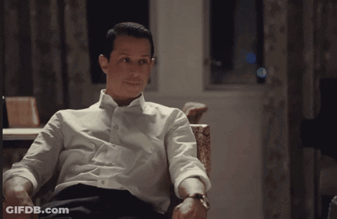 Man In Suit Standing In Front Of Blackboard GIF