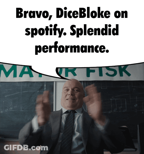 Man In Suit Standing In Front Of Bravo Dicebloke Sign GIF