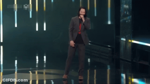 Man In Suit Standing In Front Of Breathtaking Screen GIF