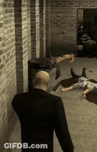 Man In Suit Standing In Front Of Brick Wall With Dead People GIF