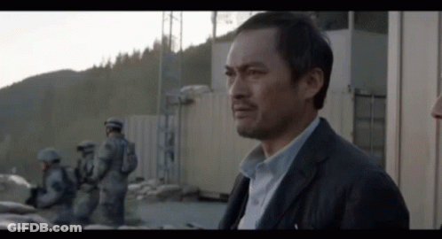 Man In Suit Standing In Front Of Building GIF