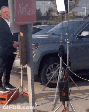 Man In Suit Standing In Front Of Car Saying Who GIF