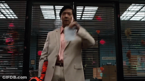 Man In Suit Standing In Front Of Corps-Center Sign GIF