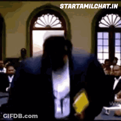 Man In Suit Standing In Front Of Crowd GIF
