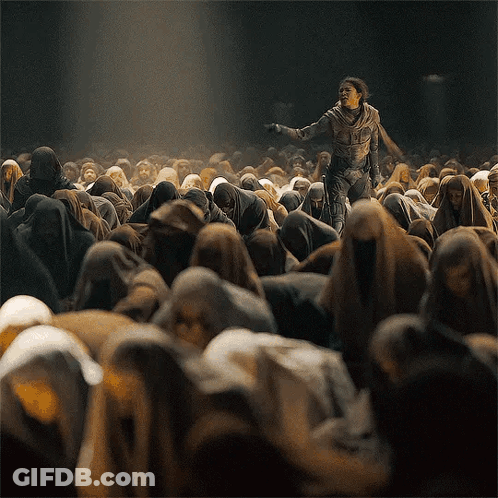 Man In Suit Standing In Front Of Crowd GIF