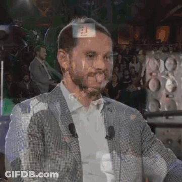 Man In Suit Standing In Front Of Crowd GIF