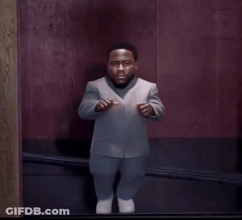 Man In Suit Standing In Front Of Door GIF