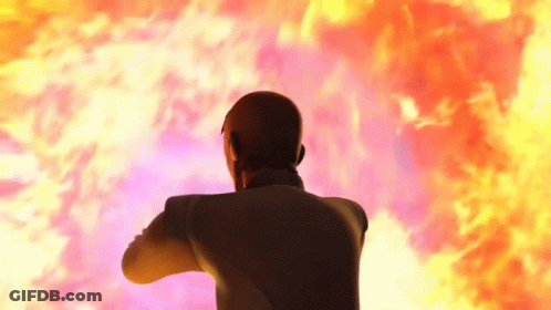 Man In Suit Standing In Front Of Fireball GIF