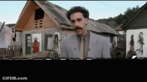 Man In Suit Standing In Front Of House GIF