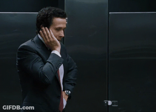 Man In Suit Standing In Front Of I'm Jacked To The Sign GIF