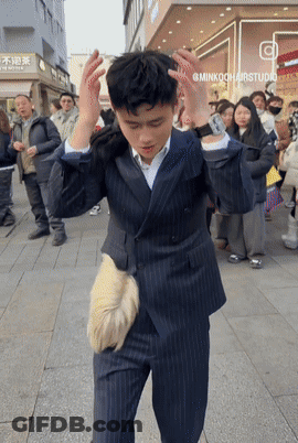 Man In Suit Standing In Front Of Minkookhairstudio GIF