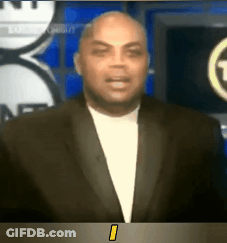 Man In Suit Standing In Front Of NBC TV Screen GIF