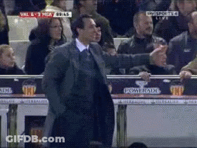 Man In Suit Standing In Front Of Powerade Advertisement GIF
