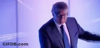 Man In Suit Standing In Front Of Projection Screen GIF