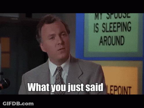 Man In Suit Standing In Front Of Sign Saying My Spouse Is Sleeping Around GIF