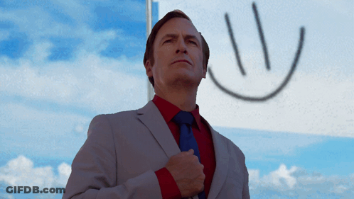 Man In Suit Standing In Front Of Smiley Flag GIF