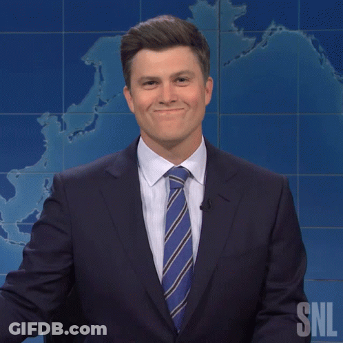 Man In Suit Standing In Front Of SNL Sign GIF