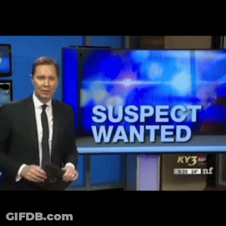 Man In Suit Standing In Front Of TV Saying Suspect Wanted GIF