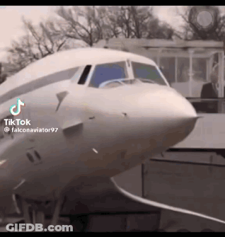 Man In Suit Standing In Front Of White Airplane GIF