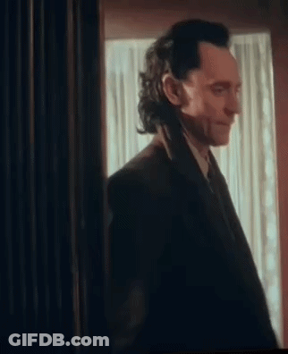 Man In Suit Standing In Front Of Window GIF