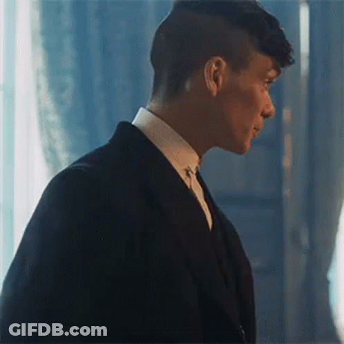 Man In Suit Standing In Front Of Window GIF