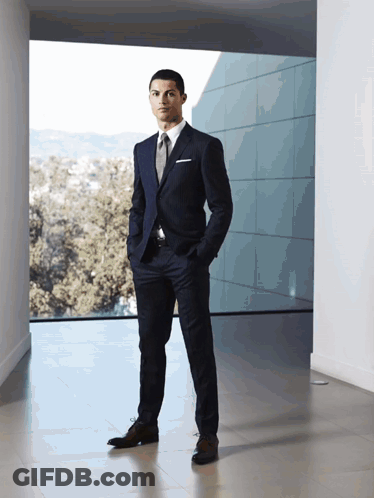 Man In Suit Standing In Front Of Window GIF