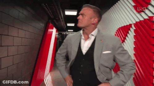 Man In Suit Standing In Hallway GIF