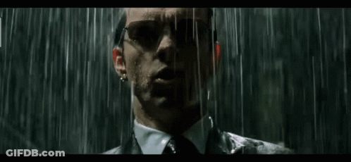 Man In Suit Standing In Rain With Sunglasses GIF