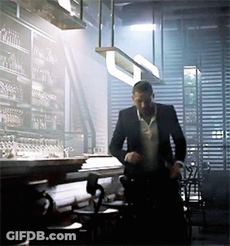 Man In Suit Standing In Restaurant GIF