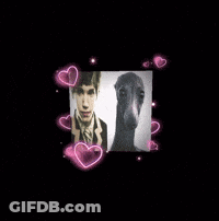 Man In Suit Standing In Snow With Ballerina Background GIF