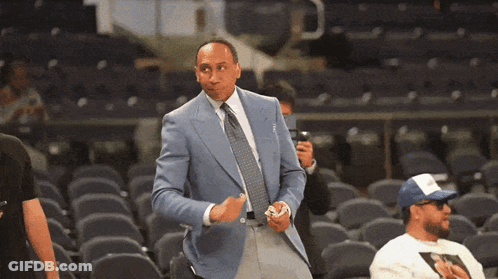 Man In Suit Standing In Stadium GIF
