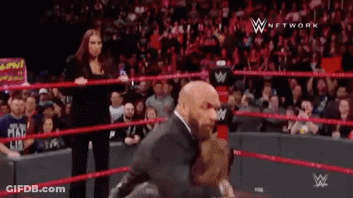 Man In Suit Standing In Wrestling Ring GIF