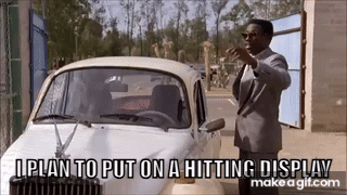 Man In Suit Standing Next To Car Saying I Plan To Put On A Hitting Display GIF
