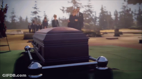 Man In Suit Standing Next To Coffin GIF
