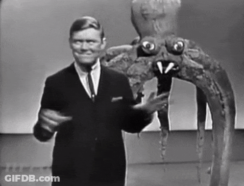 Man In Suit Standing Next To Giant Octopus GIF